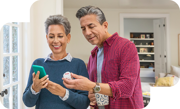 A couple checking details of prescription using a cell phone.